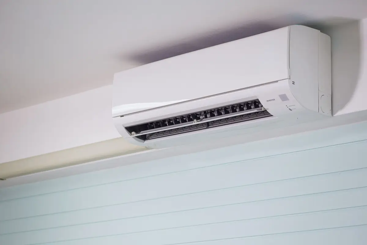Al Nafeh technician servicing a split AC unit in a Dubai apartment
