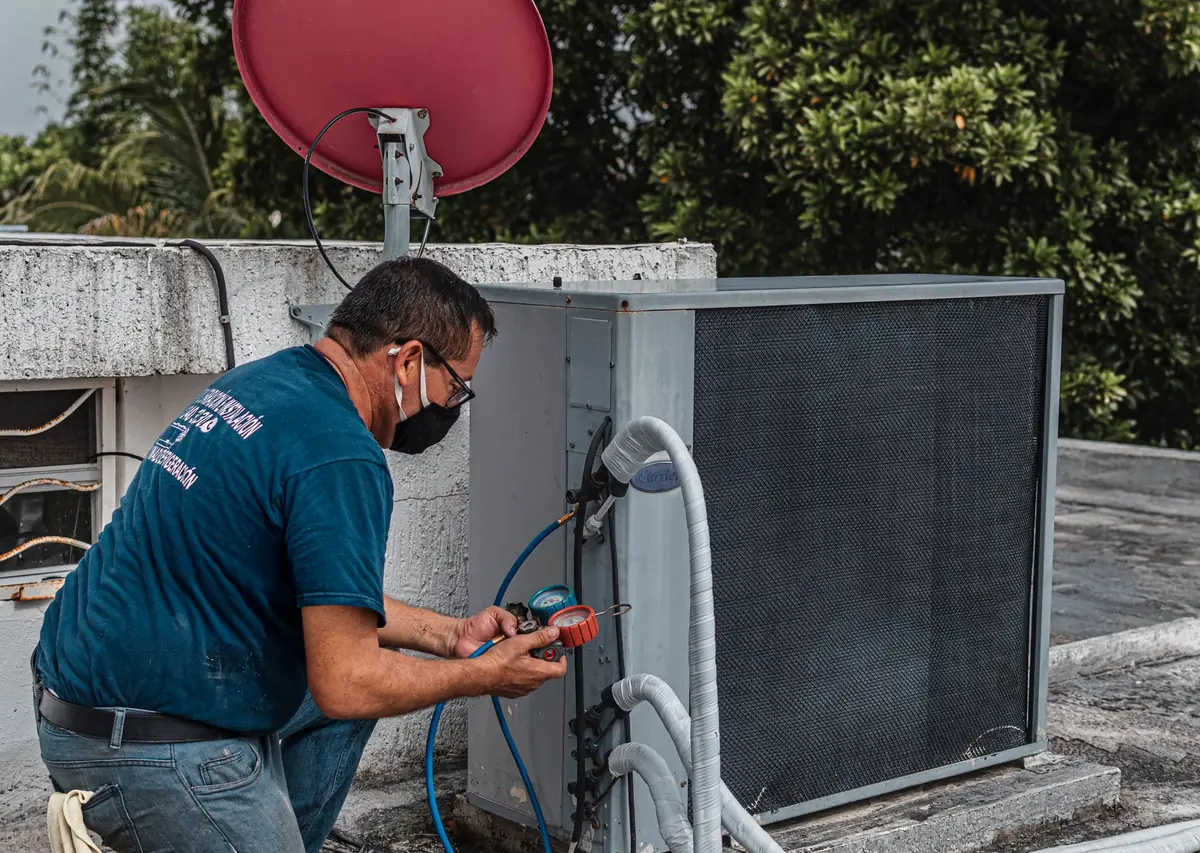 Al Nafeh technician checking an AC unit’s refrigerant pressure