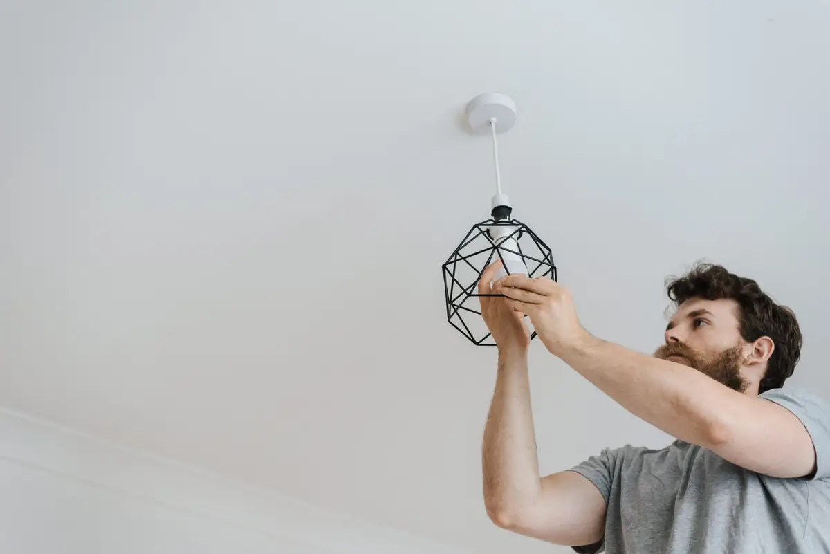 Electrician installing ceiling lighting in a Dubai home