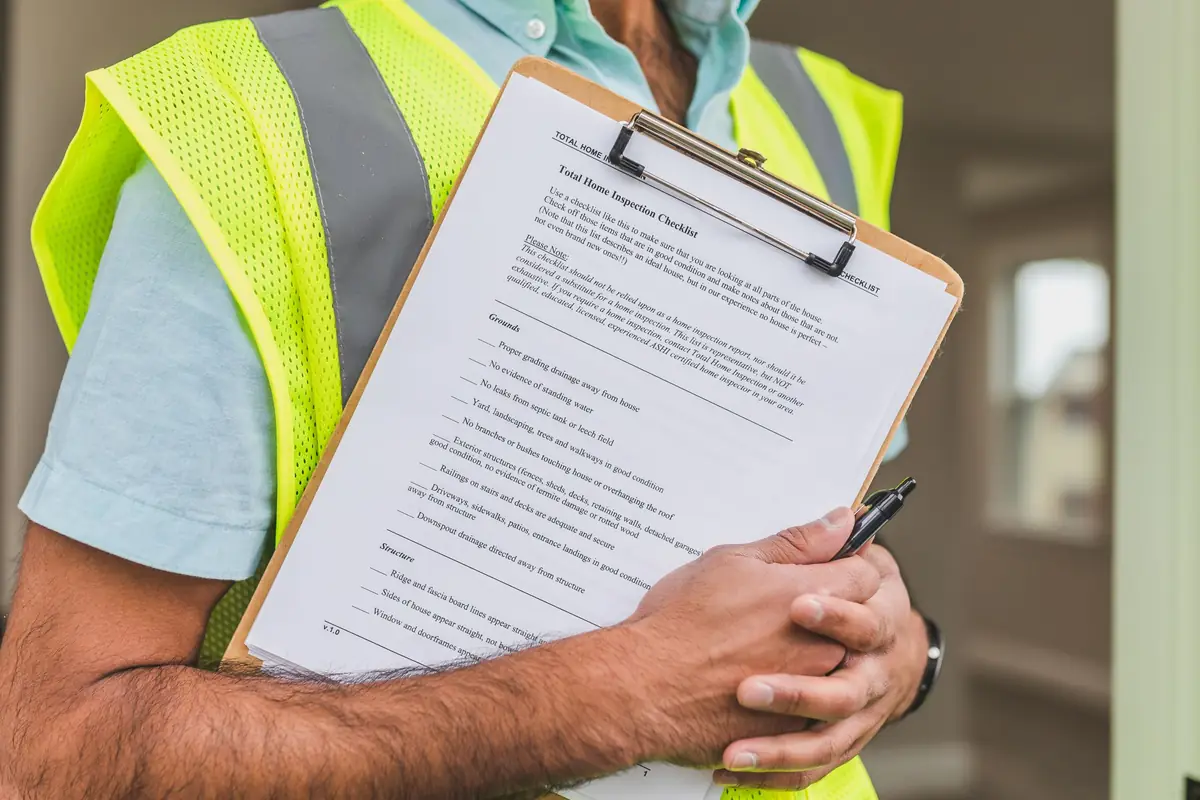 Checklist and clipboard used for a pre-summer home maintenance inspection